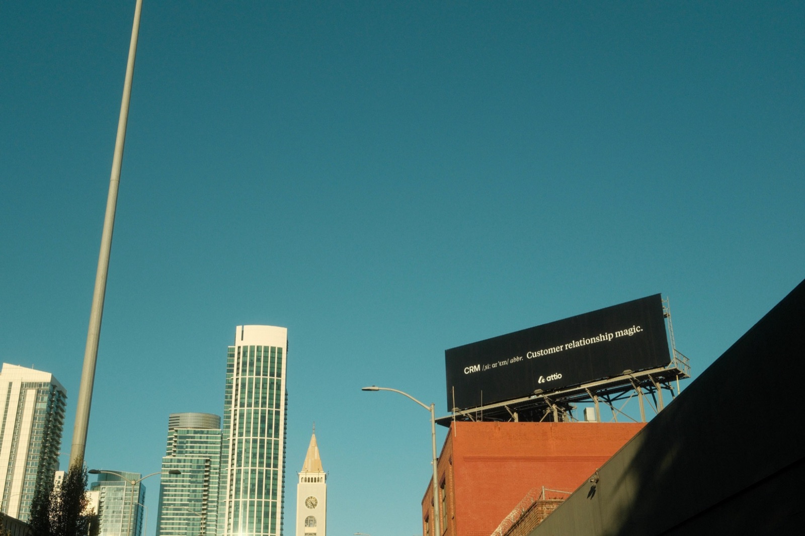 Attio billboard on a rooftop against a blue San Francisco sky, reading ‘CRM: Customer relationship magic’