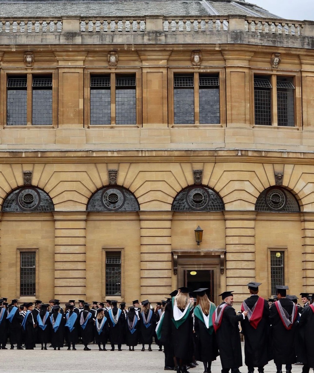 Graduates in gowns outside the Sheldonian Theatre, Oxford